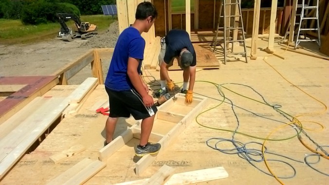 Colin and Carson assemble a ladder for the first gable end.