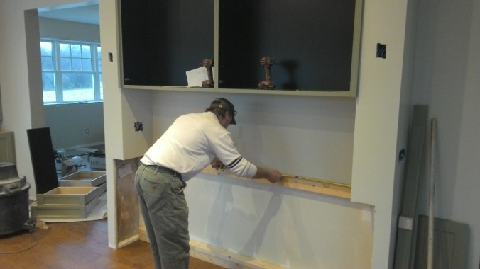 Back to rough framing: Terry installs lumber to space out the hutch cabinetry.